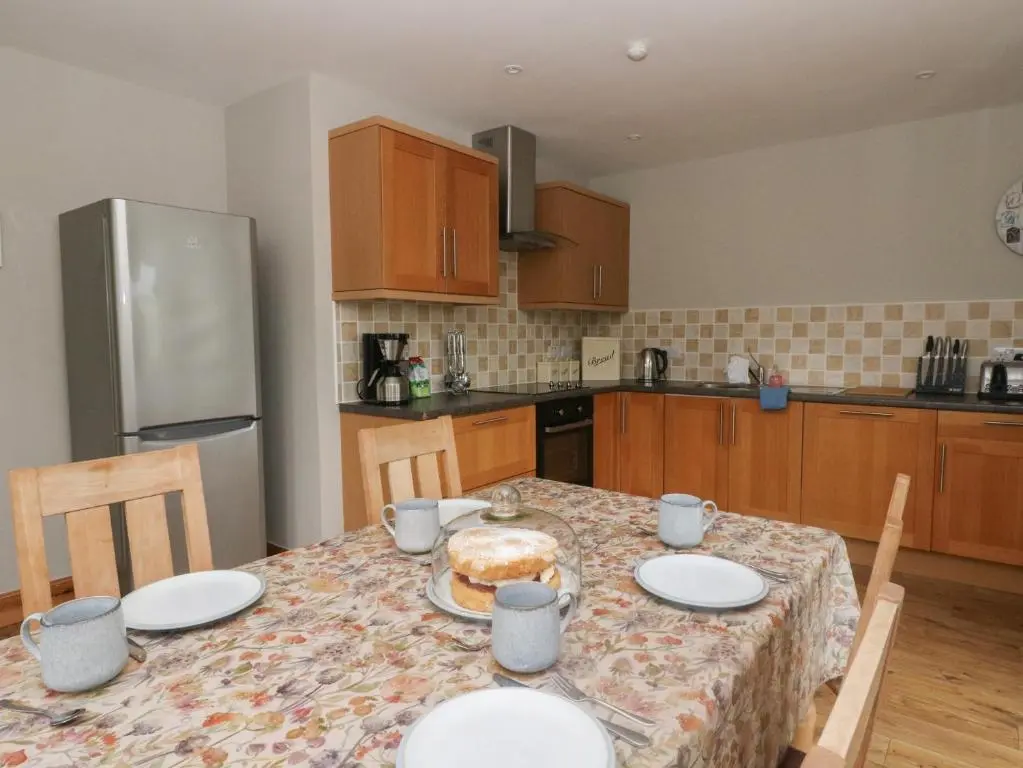 a kitchen with a table with plates of food on it at Taffs Barn in Fortrose