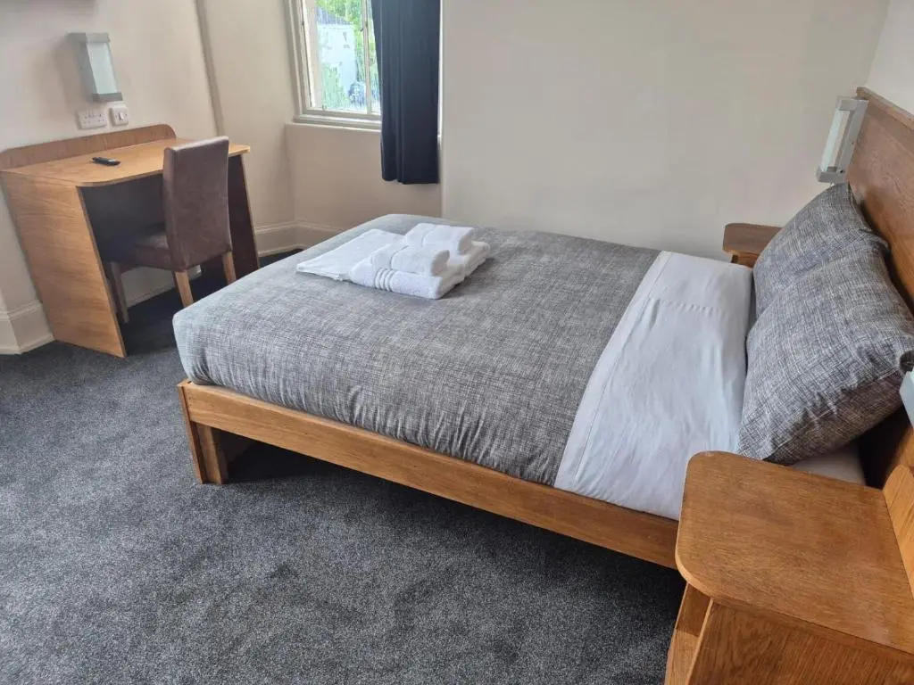 a bedroom with a bed and a desk and a desk at Bank House in Inverness