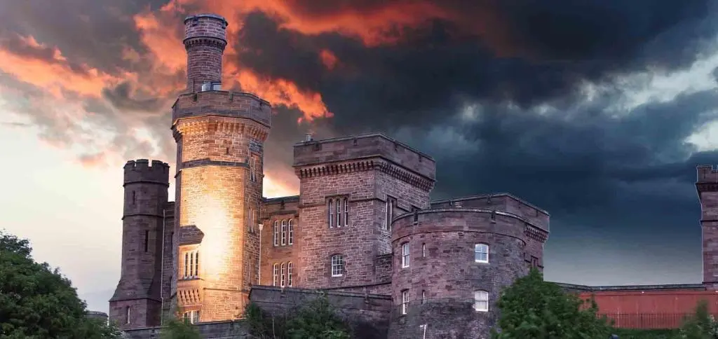 an old castle with two chimneys on top of it at Innes Street Apartment in Inverness