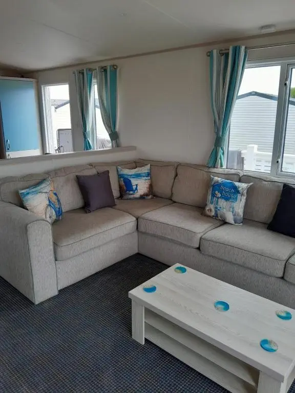 a living room with a couch and a coffee table at H26atsilversands in Lossiemouth