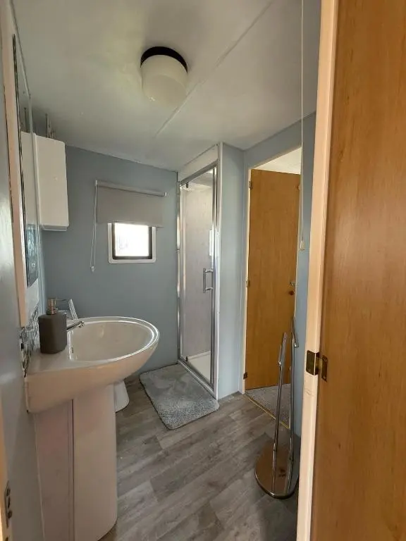 a bathroom with a tub and a sink and a shower at Caravan in Banff