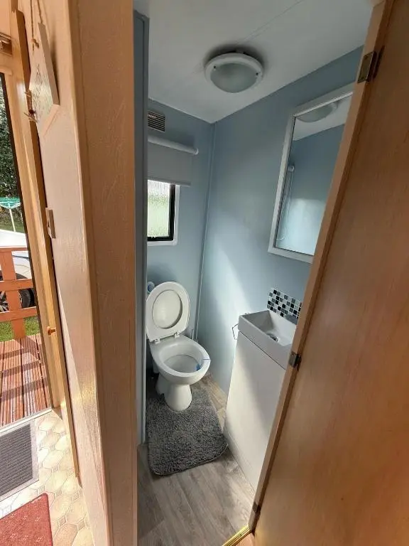 a bathroom with a toilet and a bath tub at Caravan in Banff