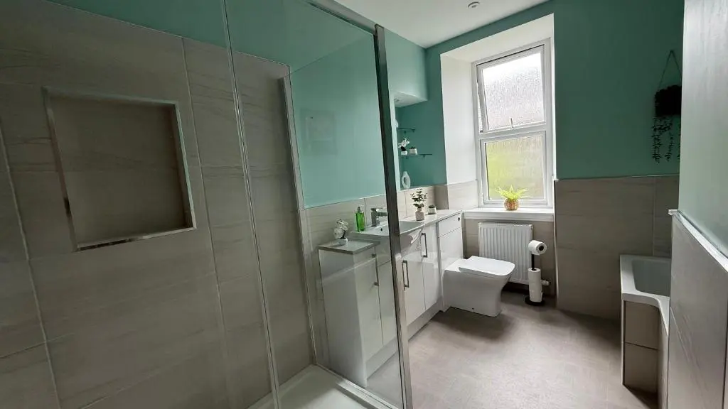 a bathroom with a shower and a toilet and a sink at The Bakehouse - by Caithness Luxury Apartments NC500 - 5 Bedroom Luxury Holiday Home - Sleeps Work teams upto 5 & holiday makers upto 10 in Wick