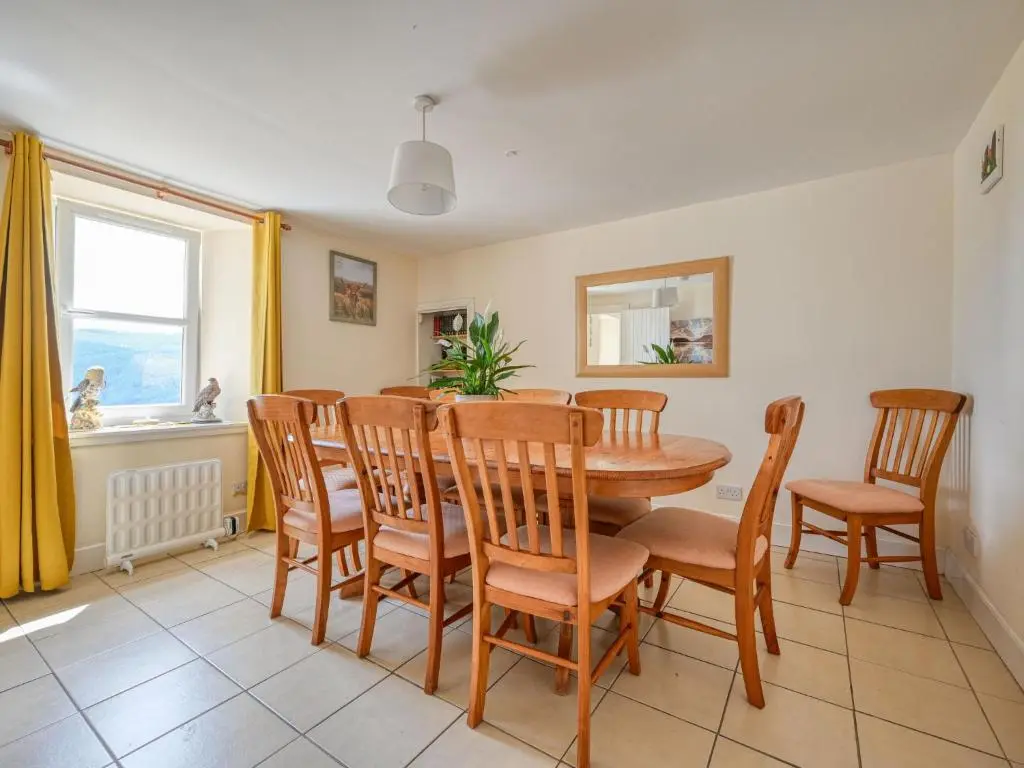 a dining room with a table and chairs at Holiday Home The Manor House by Interhome in Balnain