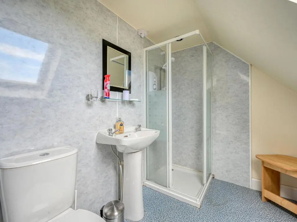 a bathroom with a shower and a toilet and a sink at Holiday Home The Manor House by Interhome in Balnain