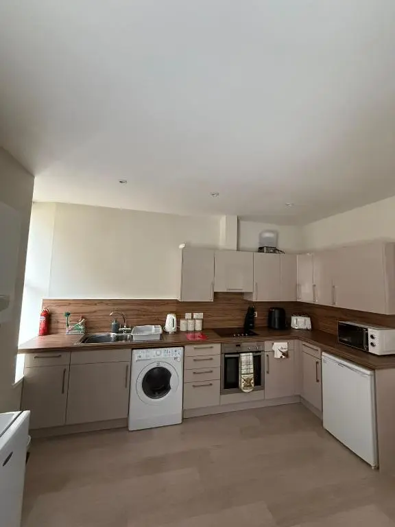 a kitchen with a sink and a washing machine at The Willows in Nairn
