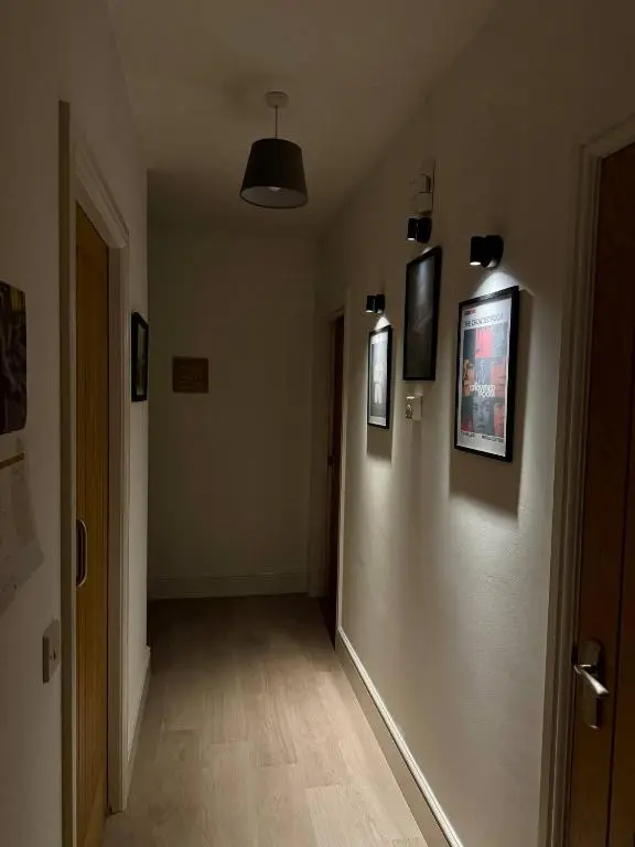 a hallway with pictures on the walls of a room at The Willows in Nairn
