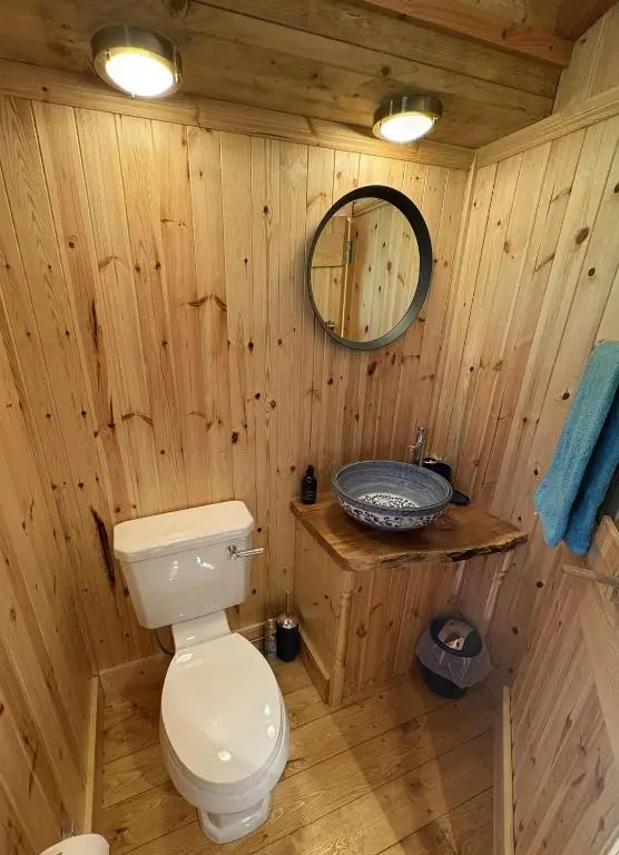 a wooden bathroom with a toilet and a sink at Shepherd's Bothy, Bothan a Bhuachaille, Black Isle in Munlochy