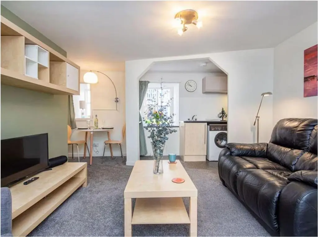 a living room with a couch and a table at 1 Bedroom Alexander Cottage-Free Parking in Inverness