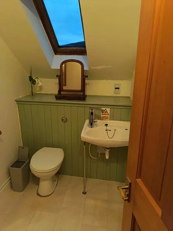 a bathroom with a toilet and a sink at River Black Water inn in Garve