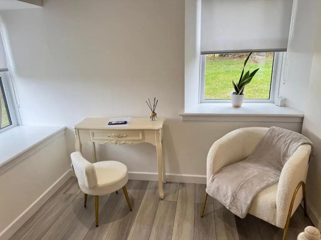 a room with a desk and two chairs and a table at Altons Bothy Guest House