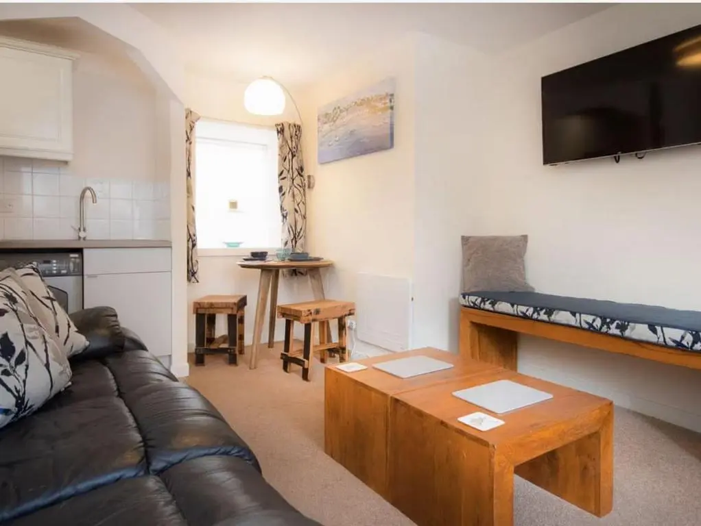a living room with a couch and a table at 1 Bedroom Alexander Courtyard-Free Parking in Inverness