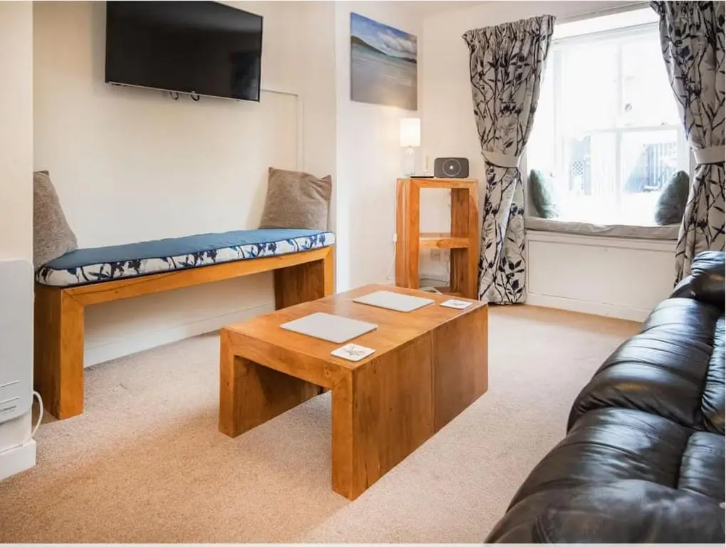a living room with a couch and a coffee table at 1 Bedroom Alexander Courtyard-Free Parking in Inverness