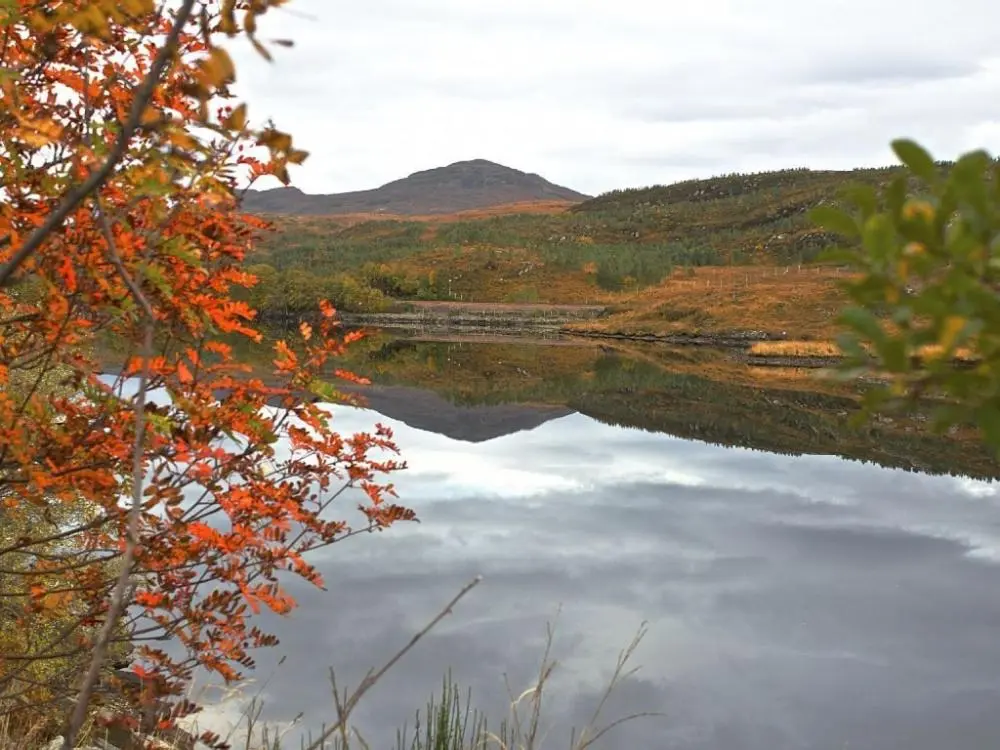 a view of a lake with a mountain in the background at Biallid House in Newtonmore