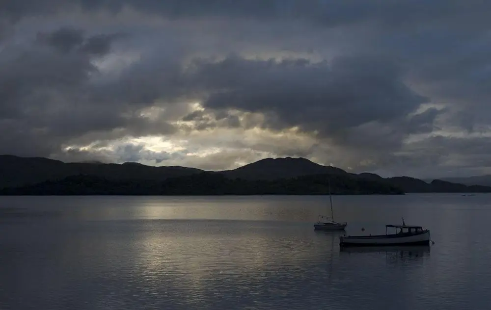 a boat sitting in the middle of a large body of water at Biallid House in Newtonmore