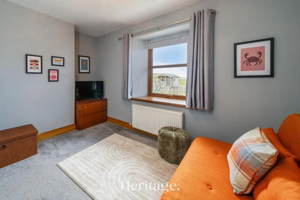 a living room with an orange couch and a window at Woodside, Get away with Hot Tub, near Fraserburgh in Strichen