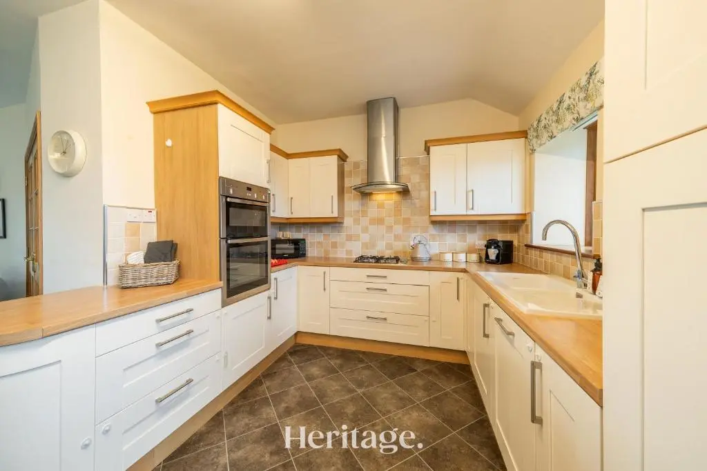 a kitchen with white cabinets and a sink at Woodside, Get away with Hot Tub, near Fraserburgh in Strichen