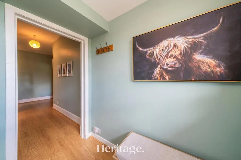 a painting of a bull hanging on a wall at Woodside, Get away with Hot Tub, near Fraserburgh in Strichen