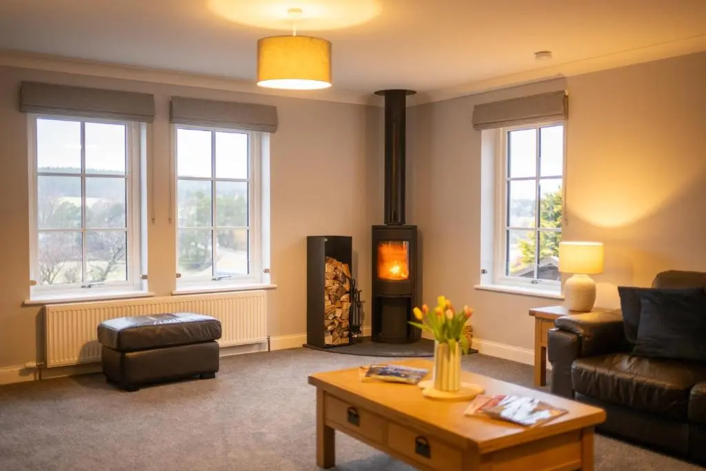 a living room with a couch and a wood stove at Glenview in Tomatin