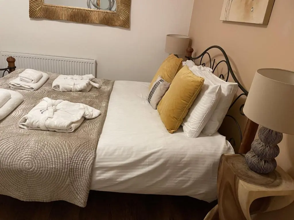a bedroom with a bed with towels on it at Romantic getaway at St Andrew's Chapel in Fort Augustus