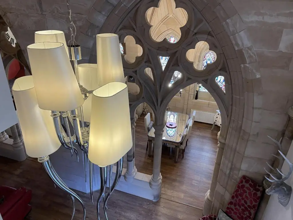 a room with a bunch of lights in a building at Romantic getaway at St Andrew's Chapel in Fort Augustus