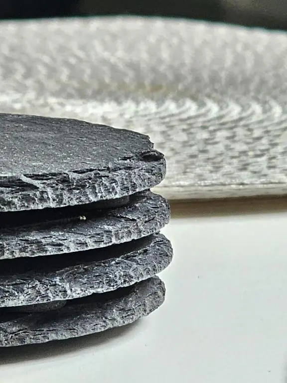a stack of black rocks next to the ocean at Central City Apartment - Inverness centre in Inverness