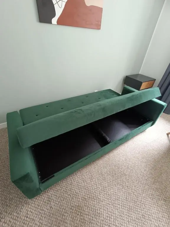 a green shelf in the corner of a room at Central City Apartment - Inverness centre in Inverness