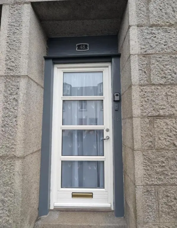 a white door in a brick building with a window at Foggiehoose based near Turriff Huntly Banff in Aberchirder