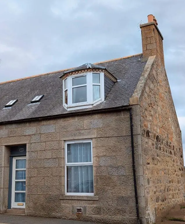 a brick building with two windows and a roof at Foggiehoose based near Turriff Huntly Banff in Aberchirder