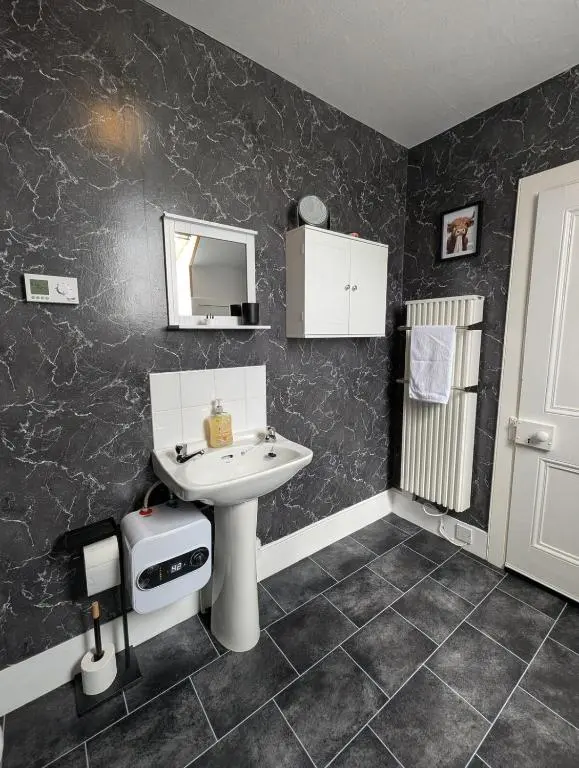 a bathroom with a sink and a mirror at Foggiehoose based near Turriff Huntly Banff in Aberchirder