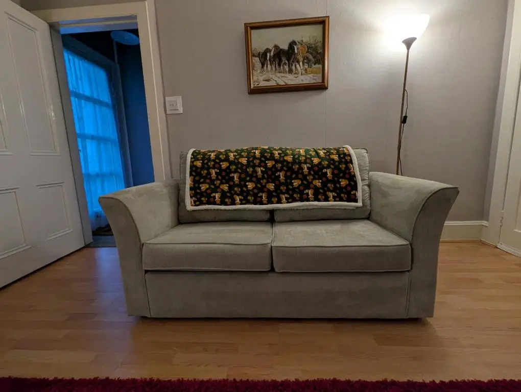 a couch with a blanket on it in a living room at Foggiehoose based near Turriff Huntly Banff in Aberchirder