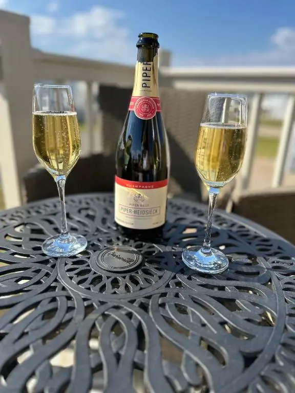 two glasses of white wine sitting on a table at Jen's Retreat in Lossiemouth