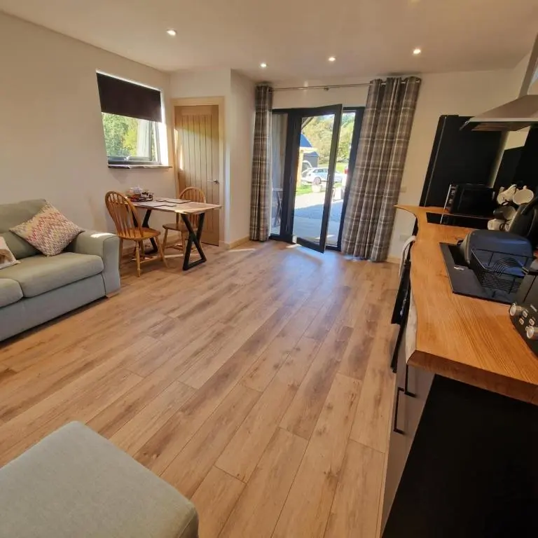 a living room with a couch and a table at Temuka Lodge in Glenurguhart