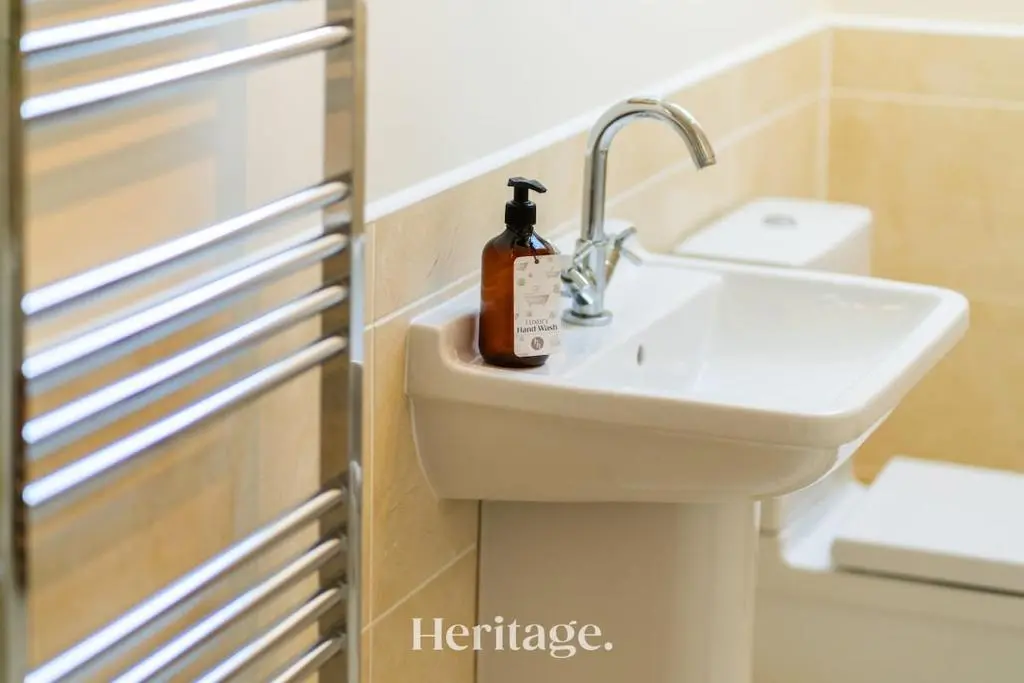 a bathroom with a sink with a soap bottle on it at Bonnieview House, Tarves, Aberdeenshire