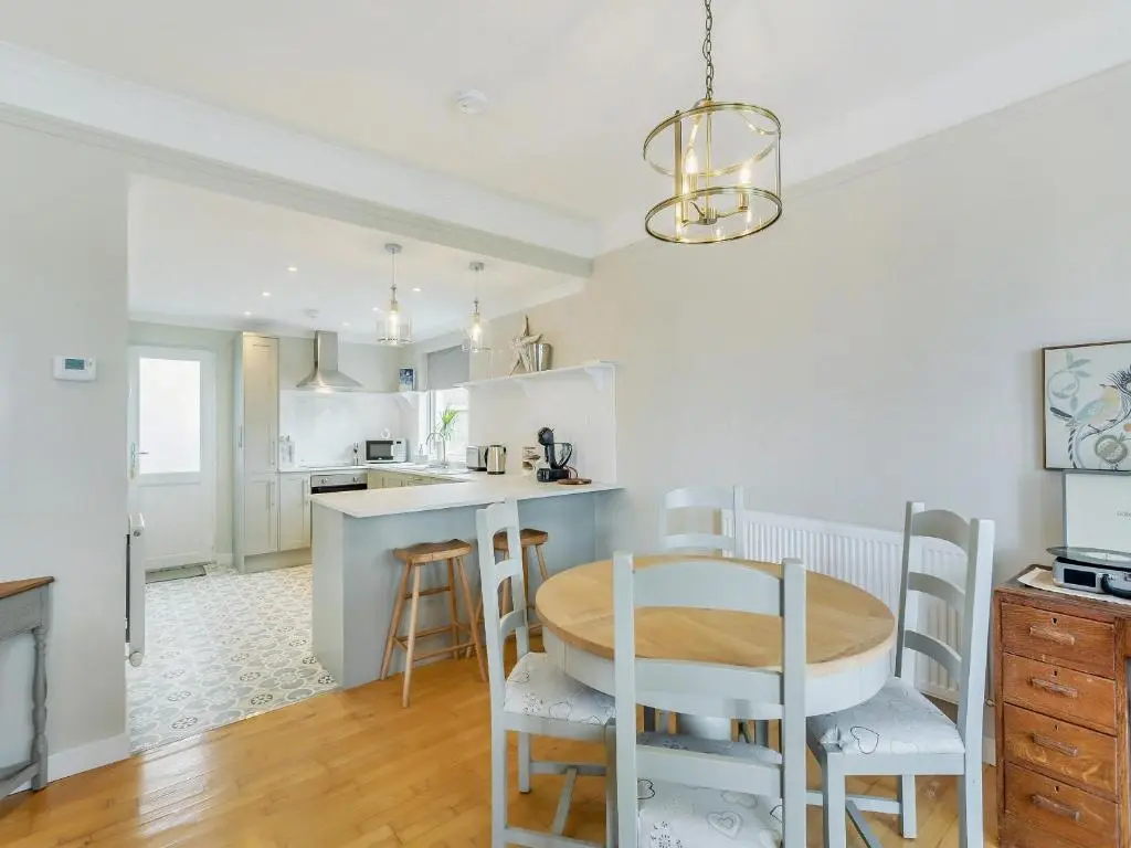 a kitchen and dining room with a table and chairs at Sea Breezes in Balintore