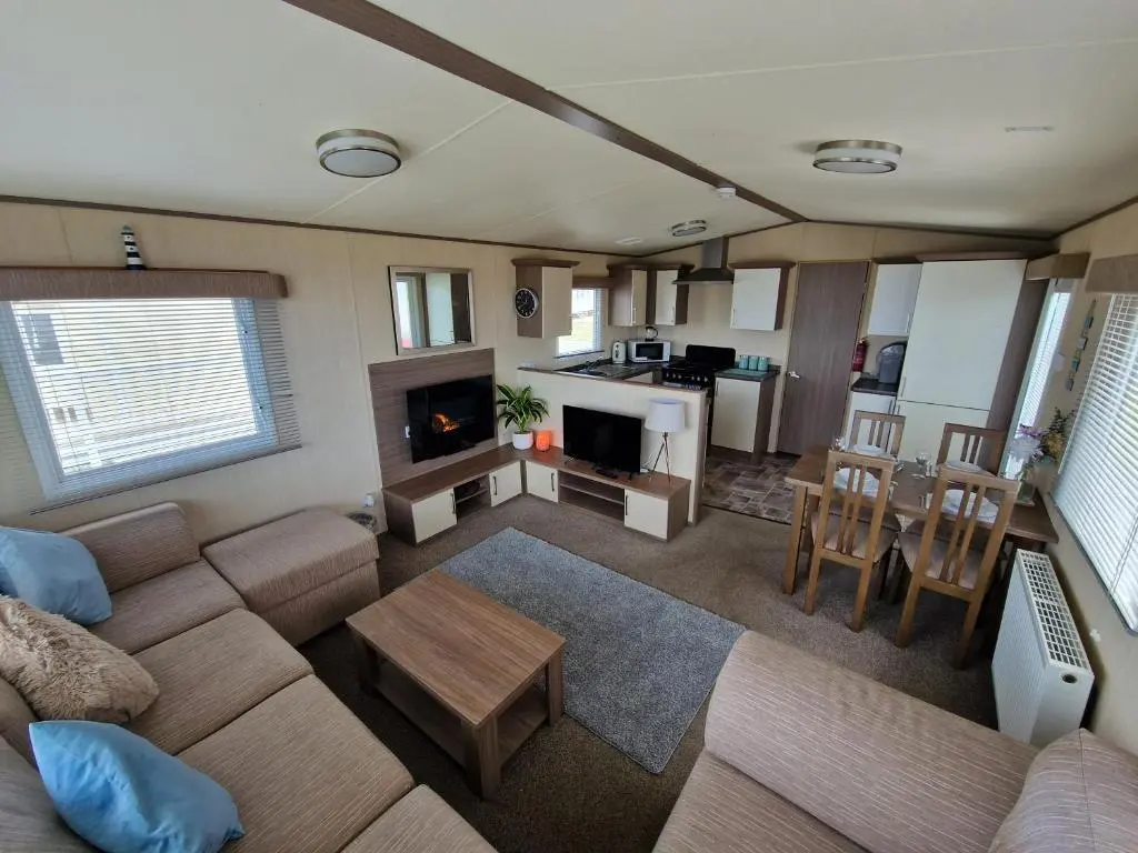 a living room with a couch and a table at Cladach in Lossiemouth