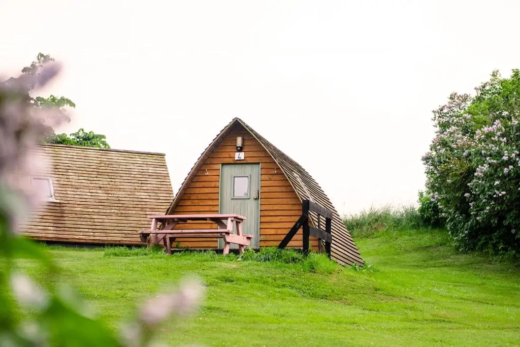 a small cabin with a picnic table in front of it at The Loft Glamping & Camping in Kinloss