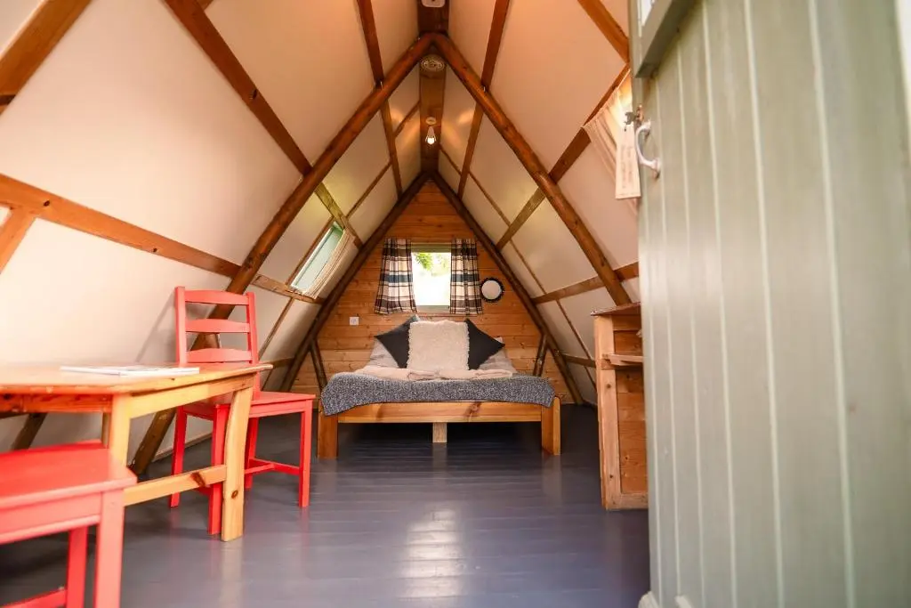 a room with a bed in the middle of a attic at The Loft Glamping & Camping in Kinloss