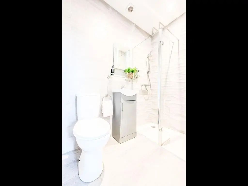 a white bathroom with a toilet and a shower at Apartment Fishertown Apartment 1st Floor by Interhome in Nairn