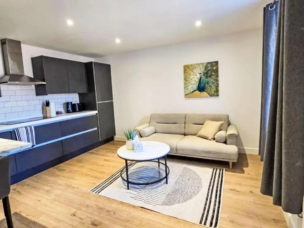 a living room with a couch and a table at Apartment Fishertown Apartment by Interhome in Nairn