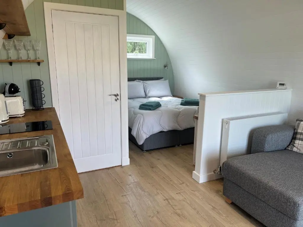 a small room with a bed and a kitchen at Barn Owl Pod - Speyside in Carron