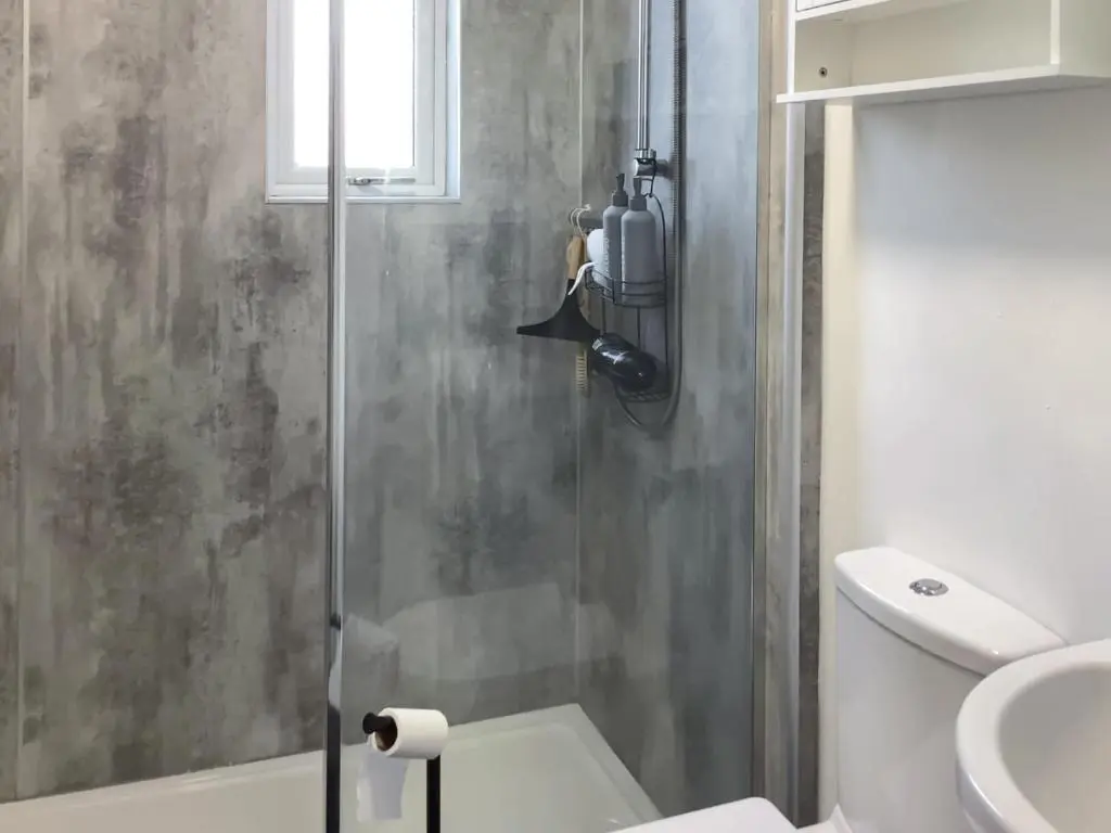 a bathroom with a shower with a toilet and a sink at Amayrah Cottage in Inverness
