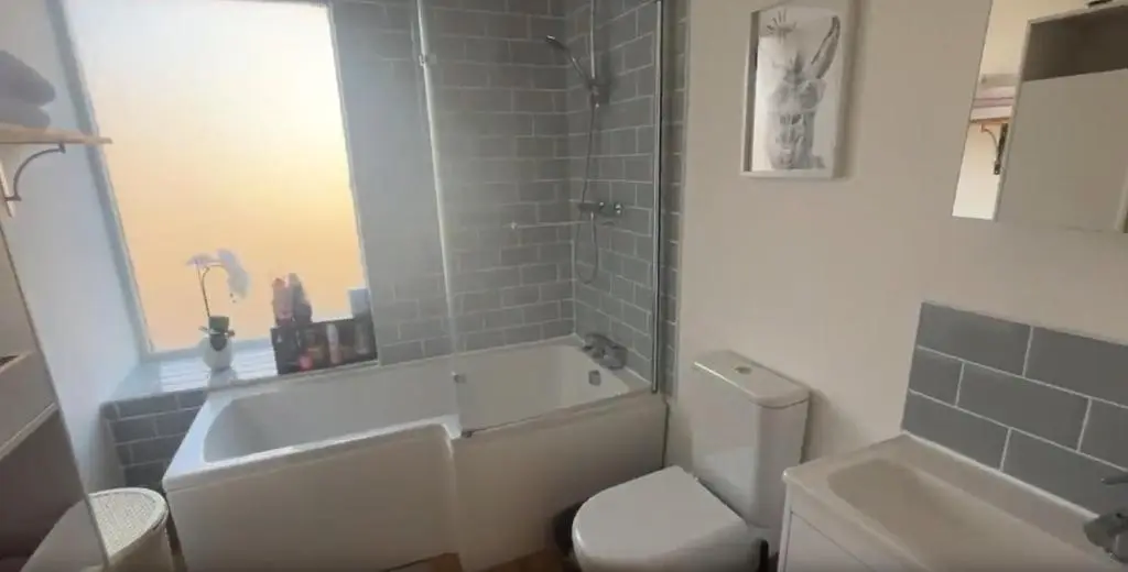 a bathroom with a tub and a toilet and a sink at White Crystal in Invergordon