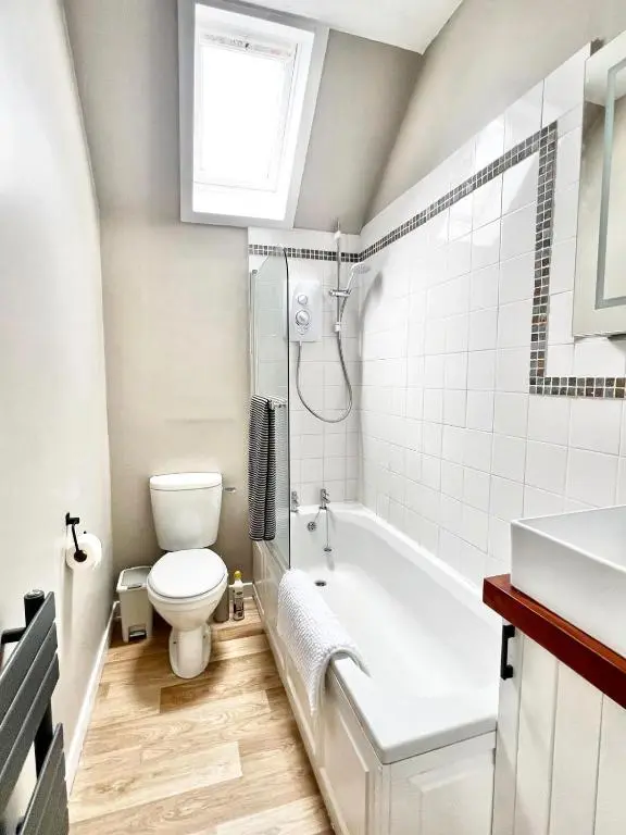 a bathroom with a toilet and a tub and a sink at Seatown Cottage - Stone's throw from beach in Lossiemouth