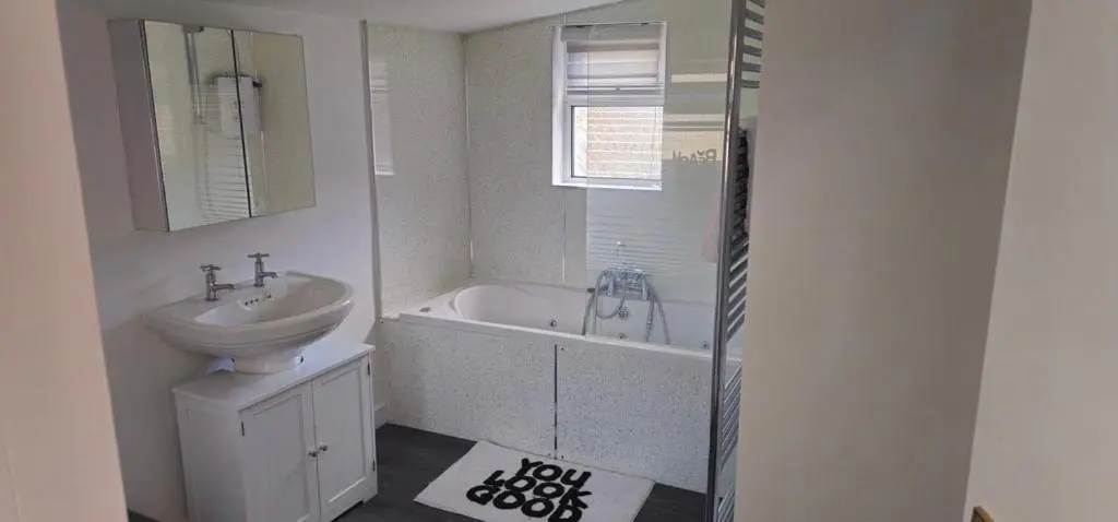a bathroom with a sink and a bath tub and a sink at Coastal Bliss, Rosehearty, Fraserburgh in Rosehearty
