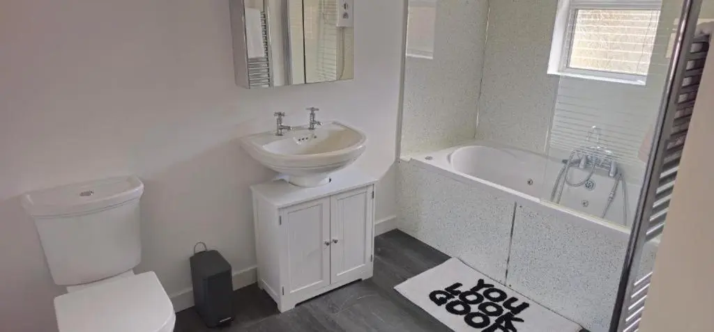 a bathroom with a sink and a toilet and a bath tub at Coastal Bliss, Rosehearty, Fraserburgh in Rosehearty