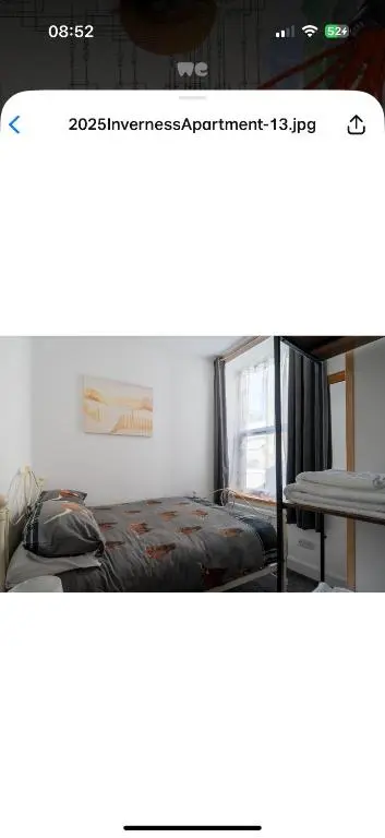 a picture of a bedroom with a bed and a table at Hawthorn villa in Dalneigh