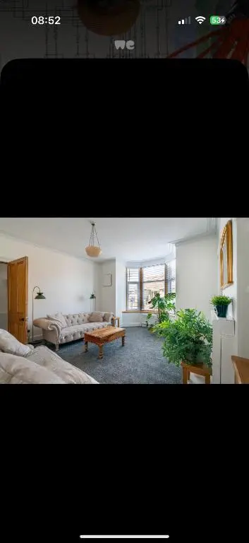 a living room with two beds and a table at Hawthorn villa in Dalneigh