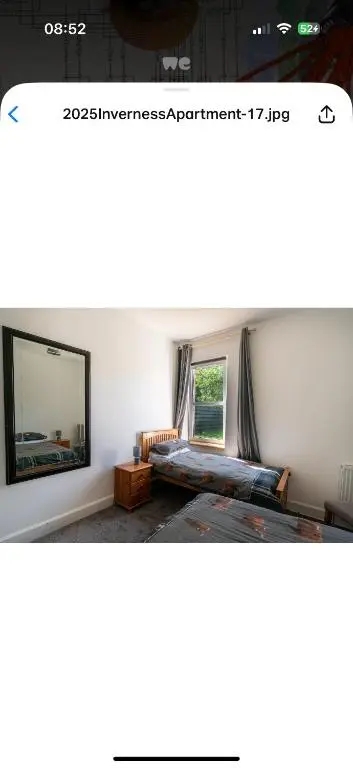a bedroom with a bed and a large mirror at Hawthorn villa in Dalneigh