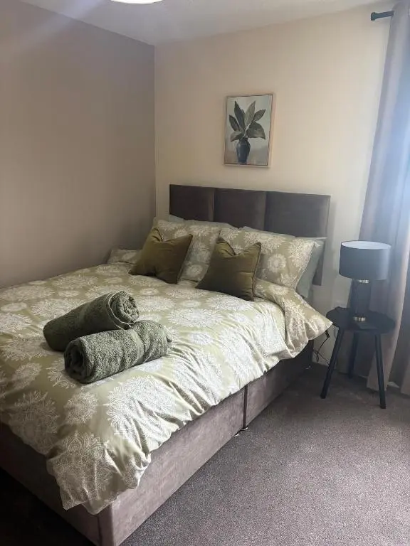 a bedroom with a large bed with a pillow on it at Number Sixteen in Kildary